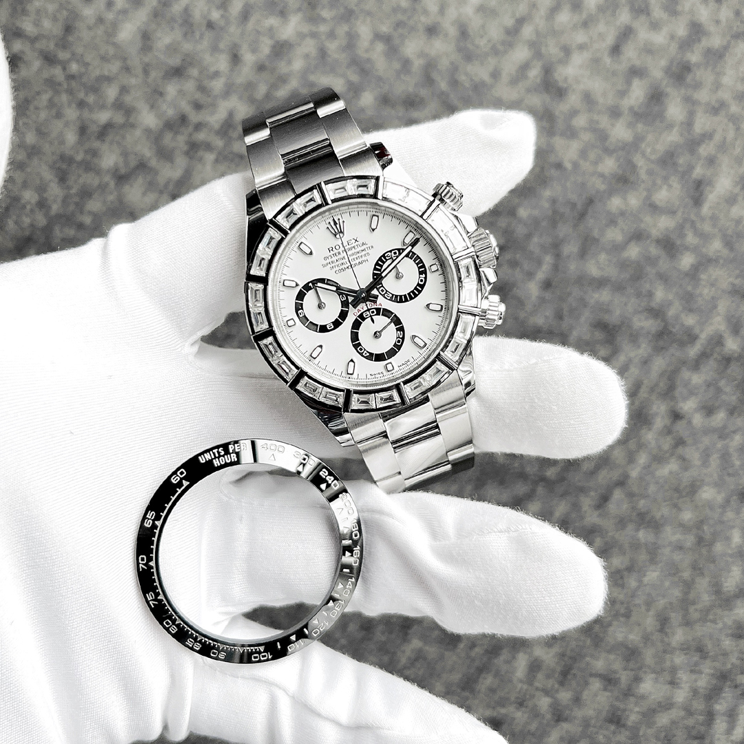 Rolex Daytona 116500LN panda dial with custom baguette diamond bezel fitted, original ceramic bezel alongside.