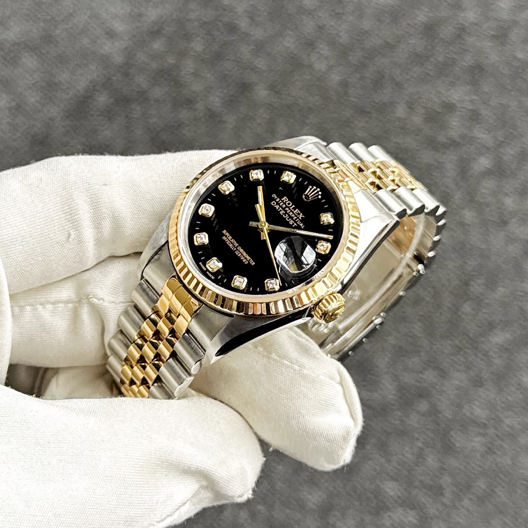 Rolex Datejust 16233 two-tone jubilee bracelet, custom black diamond dial, side angle view showing fluted bezel.
